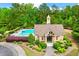 Community pool with mushroom fountain, lounge chairs, and clubhouse surrounded by lush landscaping and mature trees at 4779 Moon Hollow Ct, Buford, GA 30519