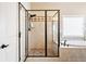 Walk in shower with tile surround, glass door, and shower head at 4779 Moon Hollow Ct, Buford, GA 30519