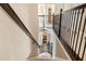 View of a staircase with wrought iron railing and carpeted steps, leading to the lower level at 4779 Moon Hollow Ct, Buford, GA 30519