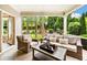 Inviting sunroom with stone floors, large windows and comfortable seating overlooks a manicured backyard at 4779 Moon Hollow Ct, Buford, GA 30519