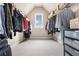 Well-lit walk-in closet with storage baskets and shelving for optimal organization at 4779 Moon Hollow Ct, Buford, GA 30519