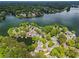 Stunning aerial view of a lakeside community featuring lush greenery and waterfront properties with private docks and boats at 6330 Spinnaker Ln, Alpharetta, GA 30005