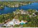 Aerial view of the community pool alongside the lake with surrounding houses and lush greenery at 6330 Spinnaker Ln, Alpharetta, GA 30005