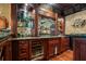 Well-stocked bar area with custom cabinets, a wine cooler, and ample storage for glassware at 6330 Spinnaker Ln, Alpharetta, GA 30005