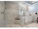 Bright bathroom features a glass shower with marble tiles, and white cabinets at 6330 Spinnaker Ln, Alpharetta, GA 30005