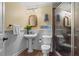 Quaint bathroom with a pedestal sink, decorative mirror, and a glass-enclosed shower at 6330 Spinnaker Ln, Alpharetta, GA 30005