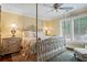 Bedroom featuring a decorative bed, hardwood floors, and bright windows at 6330 Spinnaker Ln, Alpharetta, GA 30005