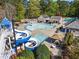 Community pool with a winding slide, shaded seating areas, and well-maintained landscaping at 6330 Spinnaker Ln, Alpharetta, GA 30005