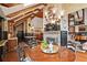 Inviting dining area with stone fireplace, wood beams, and views of the living spaces at 6330 Spinnaker Ln, Alpharetta, GA 30005
