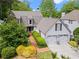 Traditional two-story home showcasing manicured landscaping, a brick walkway, and an attached two-car garage at 6330 Spinnaker Ln, Alpharetta, GA 30005