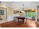 The game room features wood floors, a pool table and a view of the outdoors at 6330 Spinnaker Ln, Alpharetta, GA 30005