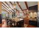 Well-appointed kitchen with granite countertops, a large island, and professional-grade appliances, highlighted by wood beams and pendant lights at 6330 Spinnaker Ln, Alpharetta, GA 30005