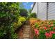 Beautifully landscaped garden path with colorful flowers and lush greenery leading to the house at 6330 Spinnaker Ln, Alpharetta, GA 30005