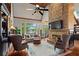 Inviting living room boasting a stone fireplace, vaulted ceilings with wood beams, and stunning views of the lake at 6330 Spinnaker Ln, Alpharetta, GA 30005