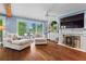 Cozy living room with fireplace, built-in bar and lake views at 6330 Spinnaker Ln, Alpharetta, GA 30005