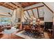 Expansive open-concept living space with a stone fireplace, beamed ceilings, and a dining area adjacent to the kitchen at 6330 Spinnaker Ln, Alpharetta, GA 30005