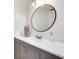 Modern bathroom featuring a sleek vanity, a round mirror, and stylish fixtures at 1205 Druid Knoll Ne Dr, Brookhaven, GA 30319