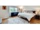 Bright bedroom with a large window, hardwood floors, and modern decor at 1205 Druid Knoll Ne Dr, Brookhaven, GA 30319