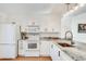 Well-lit kitchen features white cabinets, granite counters, stainless faucet and hardwood floors at 1205 Druid Knoll Ne Dr, Brookhaven, GA 30319