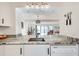 Modern kitchen with white cabinets, granite countertops, and an open layout at 1205 Druid Knoll Ne Dr, Brookhaven, GA 30319