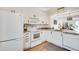 Clean kitchen features white cabinets, granite countertops, and stainless steel appliances at 1205 Druid Knoll Ne Dr, Brookhaven, GA 30319
