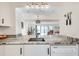 Kitchen view with stone countertops, white cabinetry, stainless steel sink, and modern appliances at 1205 Druid Knoll Ne Dr, Brookhaven, GA 30319