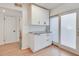 Compact kitchenette boasts white cabinets, granite countertop, and sliding door access at 1205 Druid Knoll Ne Dr, Brookhaven, GA 30319
