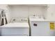 A well-lit laundry room featuring a side-by-side washer and dryer at 1205 Druid Knoll Ne Dr, Brookhaven, GA 30319