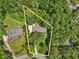 An aerial view shows a house in a wooded area. Yellow lines highlight the approximate property boundaries at 211 Black Kettle Ln, Johns Creek, GA 30022