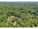 Panoramic aerial view showcasing the lush landscape surrounding a home and neighboring properties at 211 Black Kettle Ln, Johns Creek, GA 30022