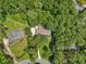 Aerial view of a home featuring a long driveway and lush green surroundings with mature trees at 211 Black Kettle Ln, Johns Creek, GA 30022