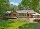 Charming home featuring a lush backyard, a spacious deck, screened porch, and a delightful vegetable garden at 211 Black Kettle Ln, Johns Creek, GA 30022