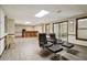 Spacious basement area featuring a bar, wood-look floors, and comfortable seating with ottomans at 211 Black Kettle Ln, Johns Creek, GA 30022