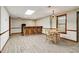 Basement showcases a bar with seating and adjacent dining area with a quaint table and chairs at 211 Black Kettle Ln, Johns Creek, GA 30022