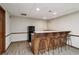 Basement featuring a kitchenette with wooden cabinets, counter space, and a mini fridge behind a bar at 211 Black Kettle Ln, Johns Creek, GA 30022