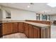 Basement kitchenette offers wooden cabinets, countertop space, and a sink with additional space for seating at 211 Black Kettle Ln, Johns Creek, GA 30022