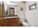 Half bathroom with granite countertops, decorative mirror, and a commode at 211 Black Kettle Ln, Johns Creek, GA 30022