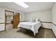 Cozy bedroom features a bed, white walls with molding, and wood-look floors at 211 Black Kettle Ln, Johns Creek, GA 30022