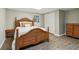 Bedroom featuring a wooden bed frame, dresser and closet at 211 Black Kettle Ln, Johns Creek, GA 30022