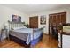 Bedroom with wood floors, decorative lighting and furniture at 211 Black Kettle Ln, Johns Creek, GA 30022