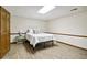 Neutral bedroom with wood-look flooring, painted walls, and an open door at 211 Black Kettle Ln, Johns Creek, GA 30022