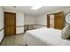 Bedroom featuring wood-look floors, neutral colors, and adjacent office area at 211 Black Kettle Ln, Johns Creek, GA 30022