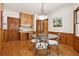 Breakfast nook features unique light fixture, backyard views, and seating for four at 211 Black Kettle Ln, Johns Creek, GA 30022