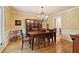 Traditional dining room featuring a chandelier, hardwood floors and an elegant china cabinet at 211 Black Kettle Ln, Johns Creek, GA 30022