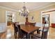 Formal dining room features hardwood floors and elegant chandelier lighting at 211 Black Kettle Ln, Johns Creek, GA 30022