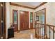 Inviting foyer with wood floors, a wooden front door and staircase at 211 Black Kettle Ln, Johns Creek, GA 30022