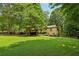 Well-maintained lawn and mature trees surrounding the home in a picturesque yard at 211 Black Kettle Ln, Johns Creek, GA 30022