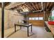 Unfinished garage with exposed ceiling, concrete floors, and a large workbench at 211 Black Kettle Ln, Johns Creek, GA 30022