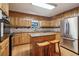 Well-lit kitchen features stainless steel appliances, an island, and wooden cabinets at 211 Black Kettle Ln, Johns Creek, GA 30022