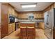 Traditional kitchen with wood cabinets, stainless appliances, and central island at 211 Black Kettle Ln, Johns Creek, GA 30022